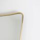 Pair of narrow gilt brass mirrors. Circa 1970.