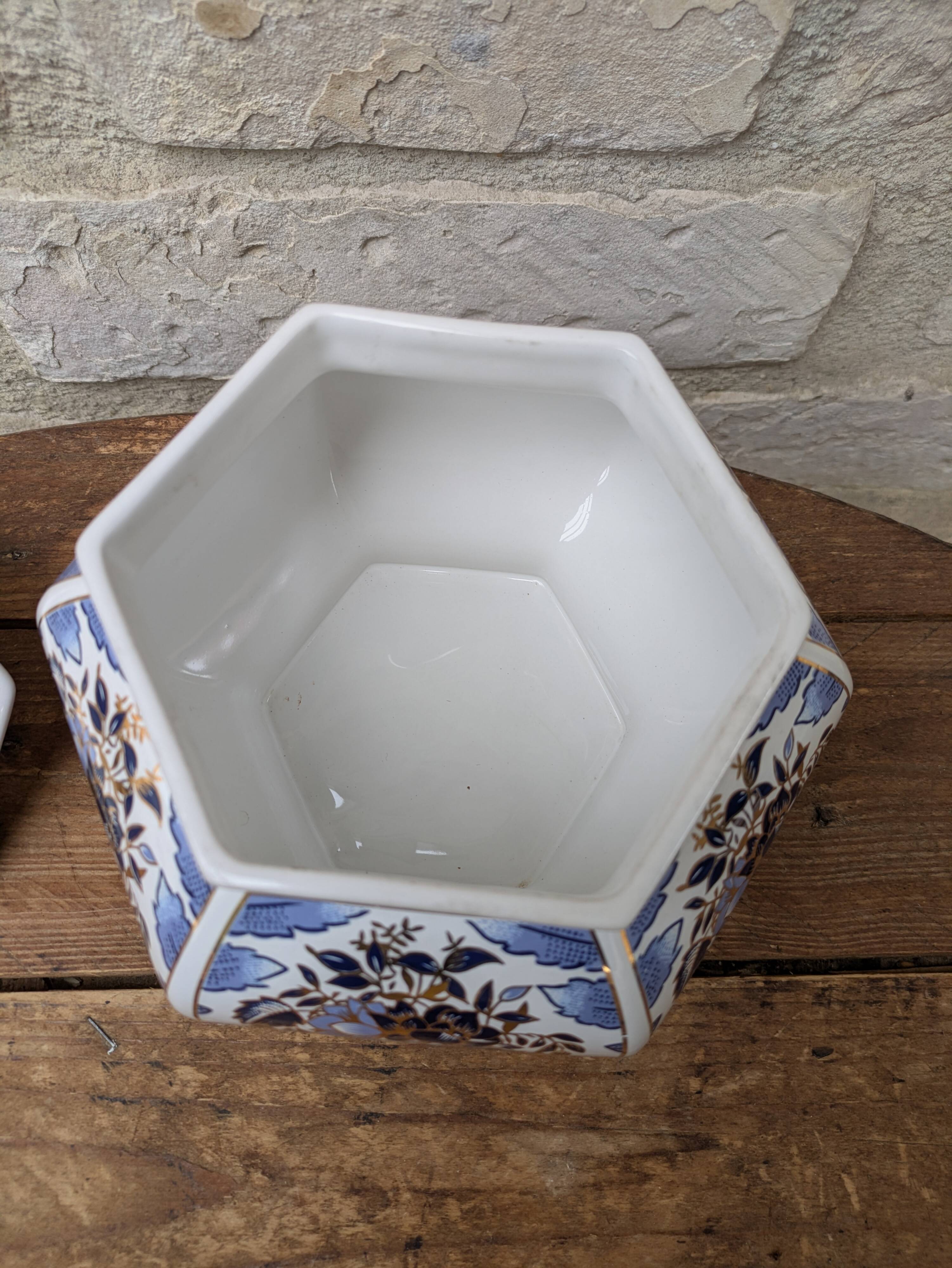 Decorative pot jar with a lid featuring a blue floral pattern and gilding.