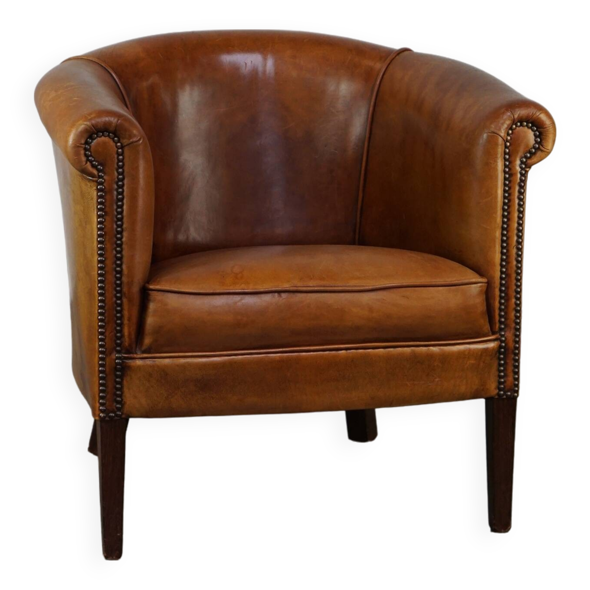 Neat and subtle sheepskin club chair, finished with decorative studs and a fixed seat cushion