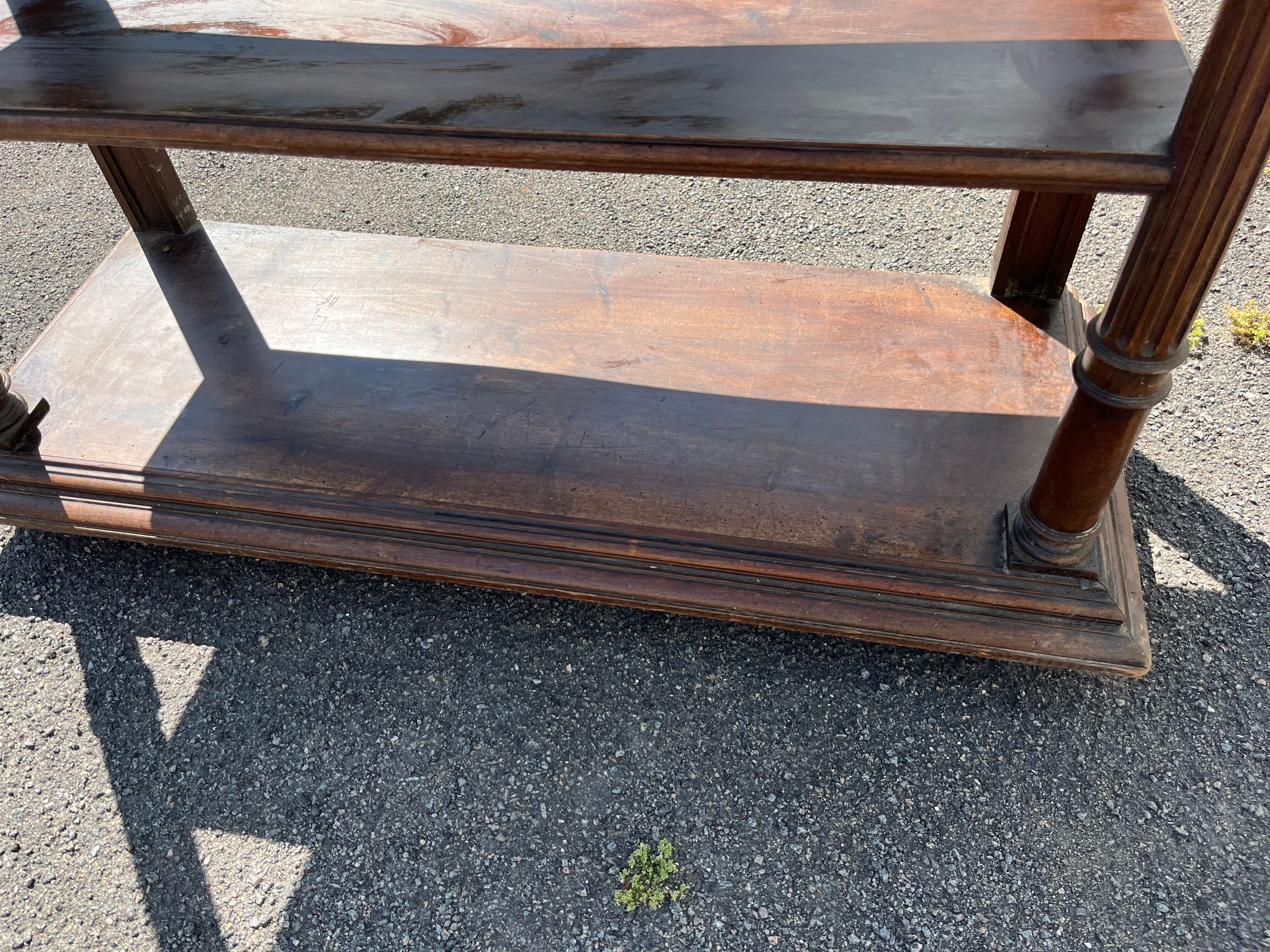 Carved wooden console table with three shelves and drop-leaf flap