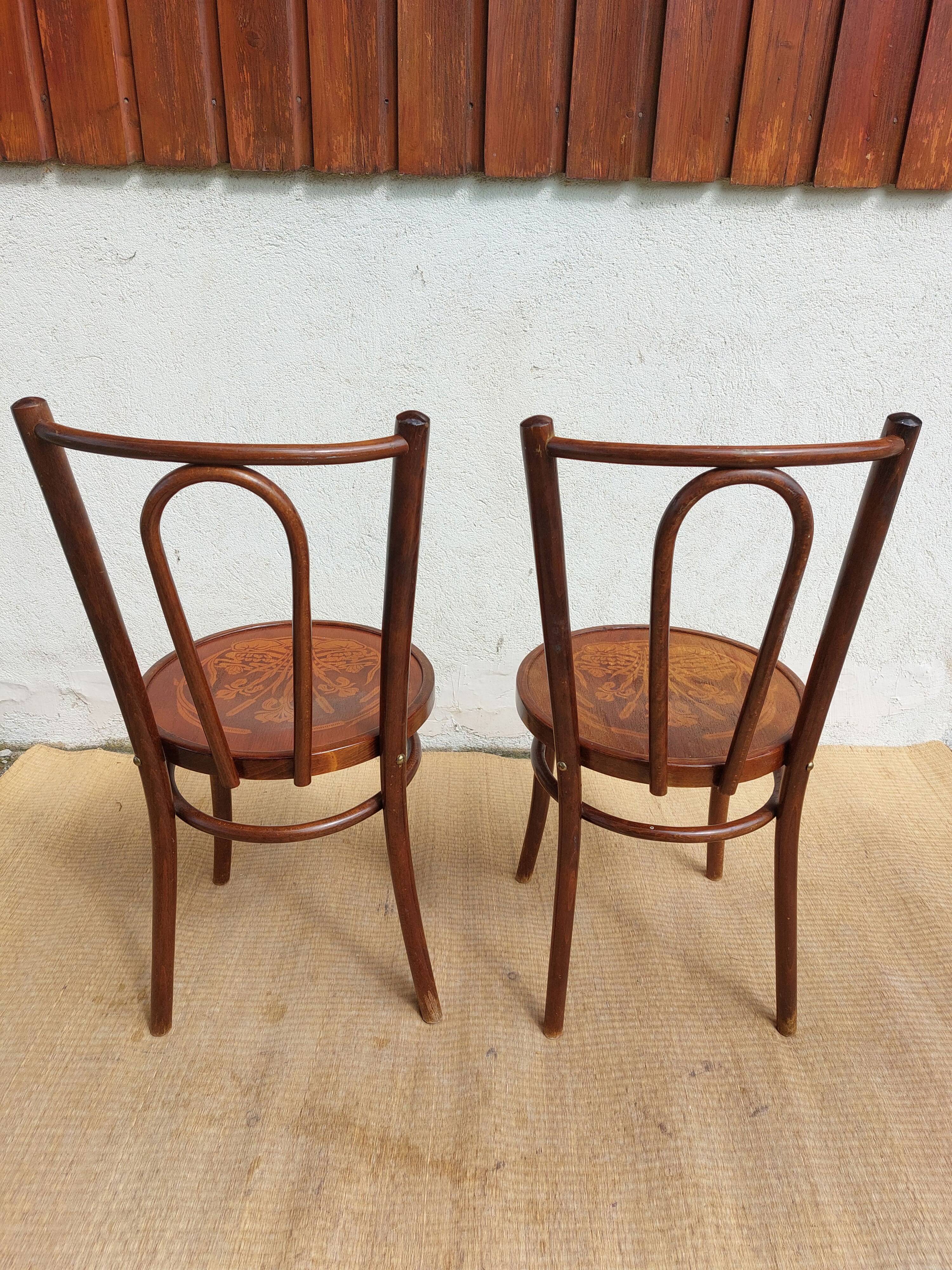 pair of bistro chairs, curved wood and pattern on the seat