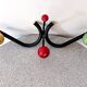 Vintage metal and wood coat rack in yellow/red/green.