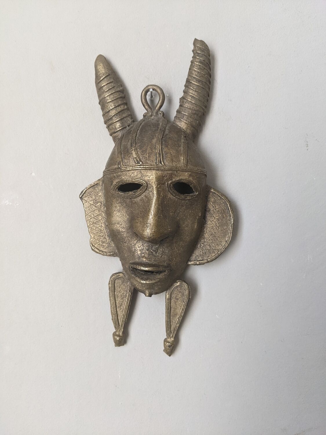 Handcrafted bronze wall mask, Sénoufo African art.