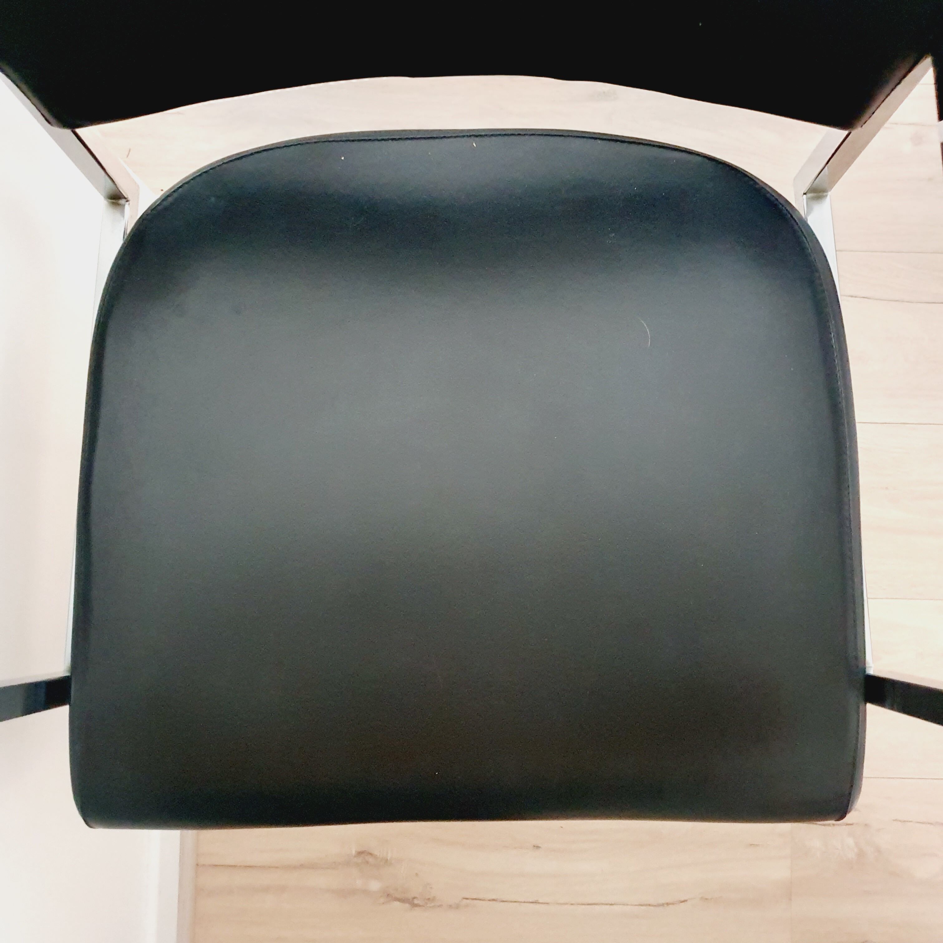 Pair of black skaï and chrome armchairs