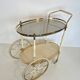 Italian oval rolling table in brass and lacquered wood.