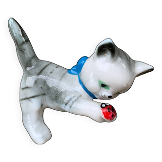 Little ceramic cat playing with a playful ladybug plays gray and white decoration
