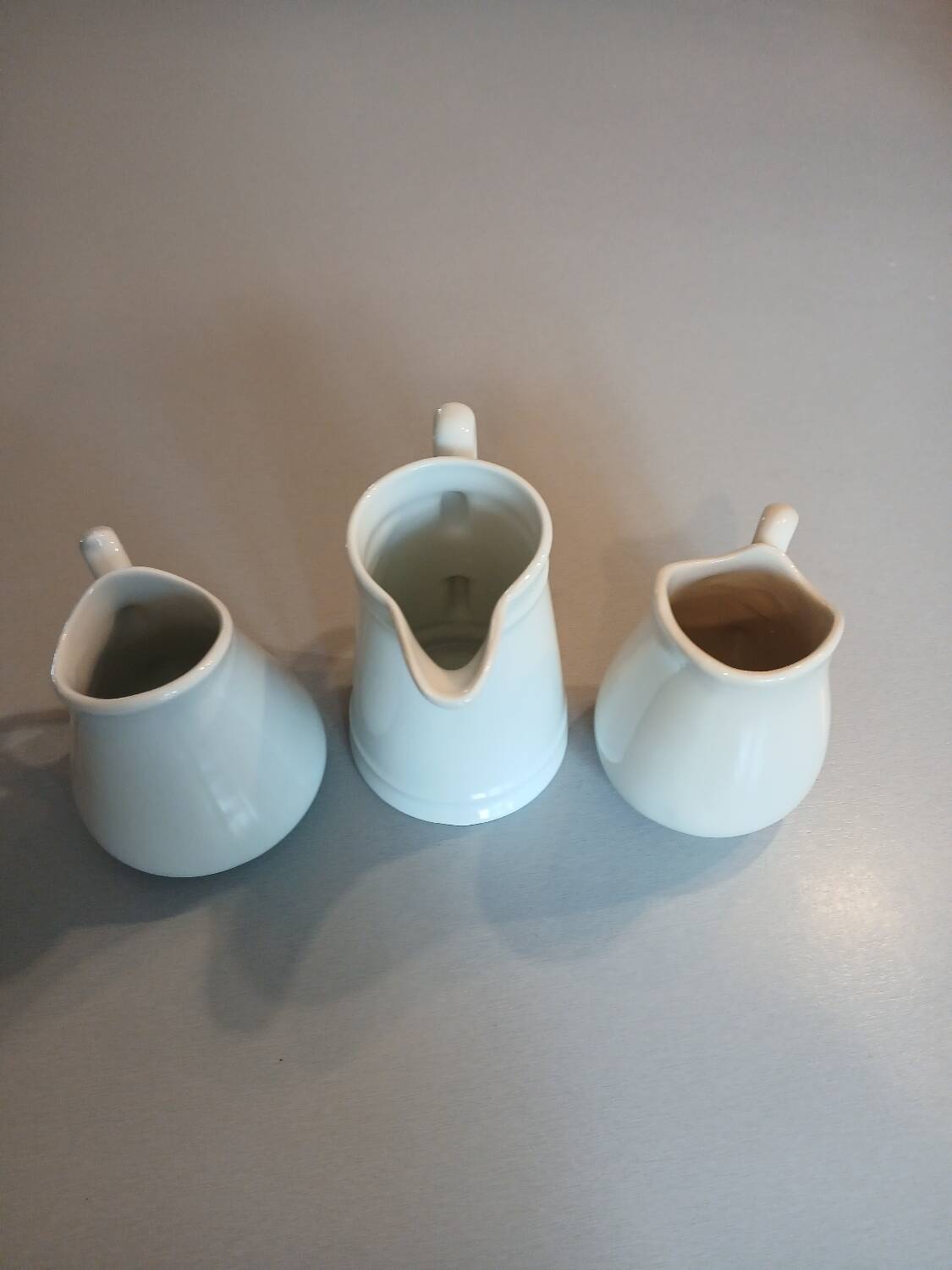 3 small antique porcelain pitchers/milk pots