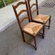 2 dining chairs in solid wood and rush, Chippendale ladder style.