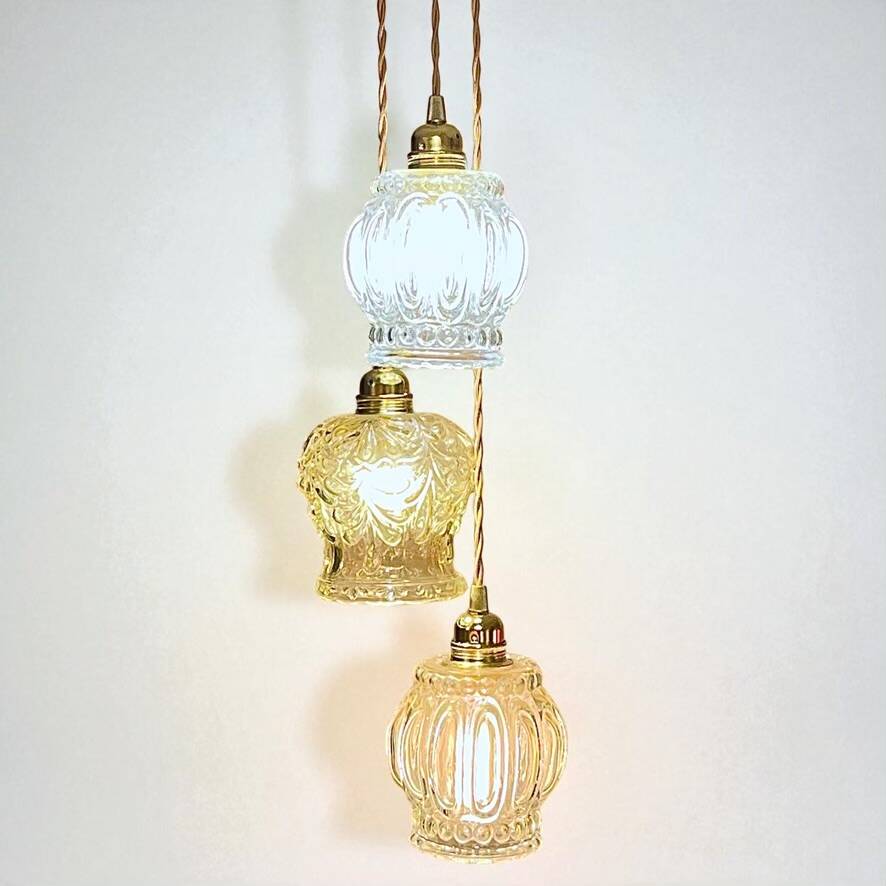 Cascade pendant light with 3 molded glass globes in vintage arabesque amber glass