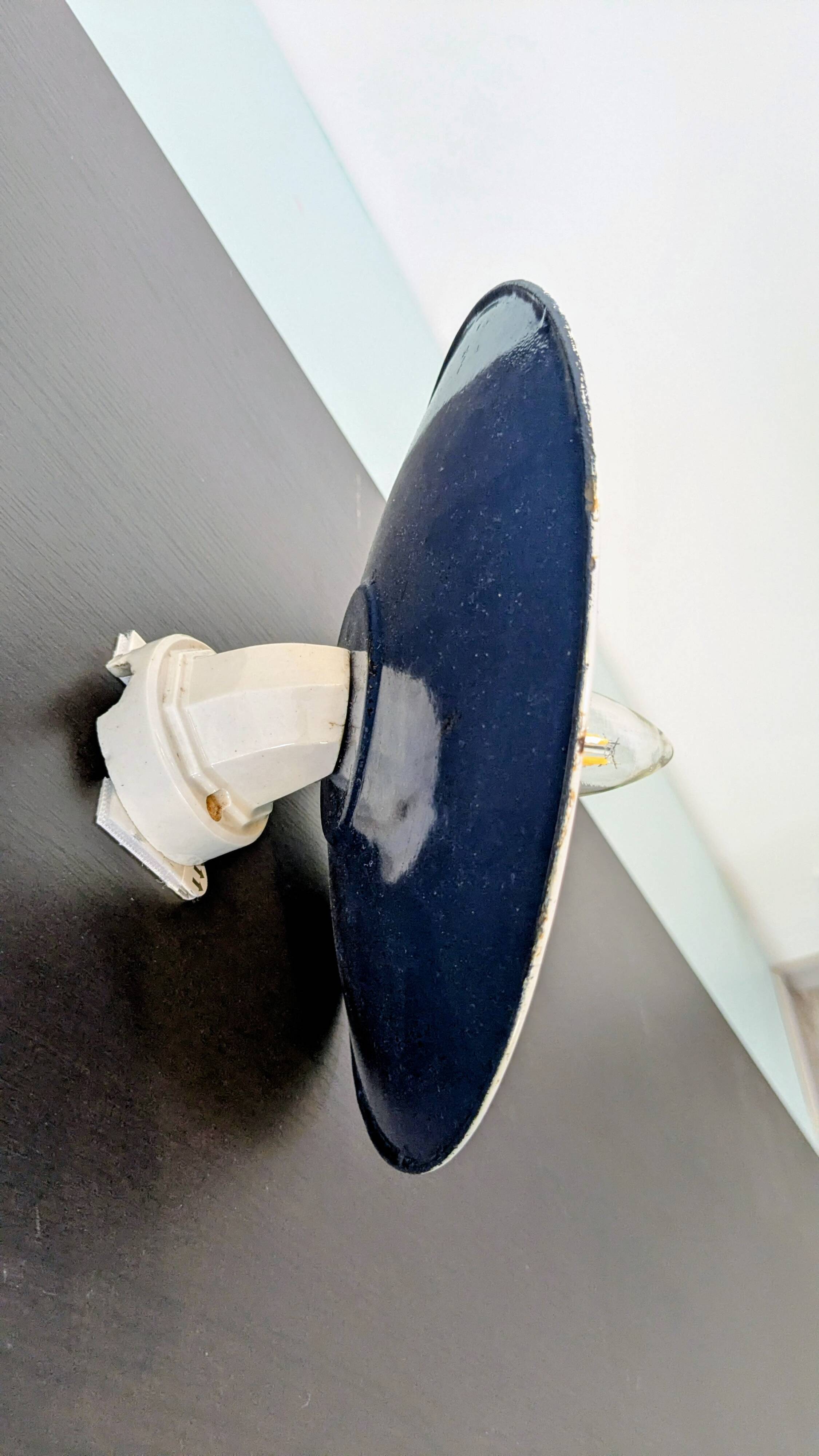 Antique wall light in blue enamel, workshop style.