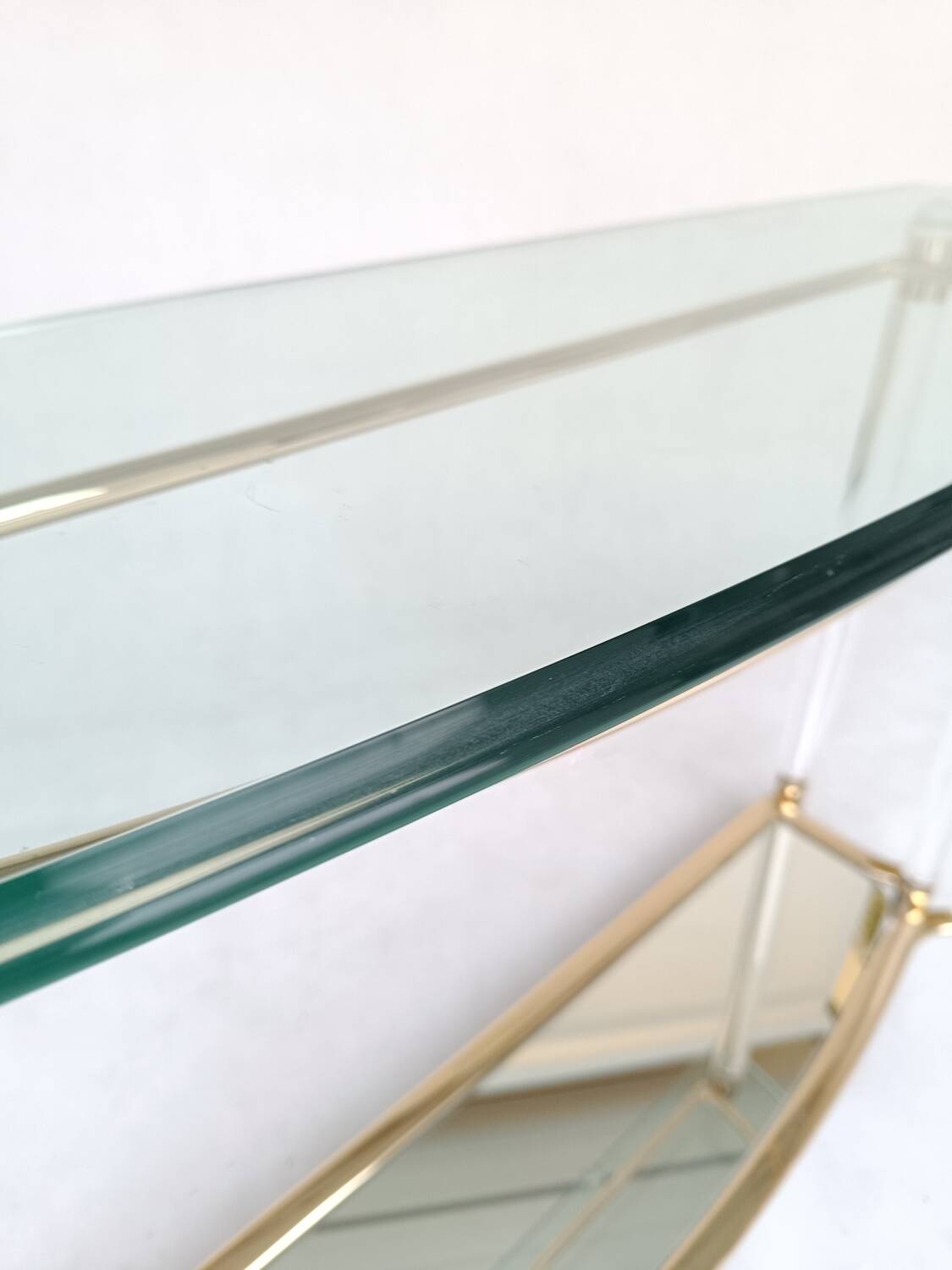Hollywood Regency console table in lucite, glass and gold metal. 1980s