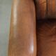 Comfortable characterful sheepskin armchair finished with decorative nails