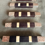 Lot 11 knife rests in ebony and silver-plated metal.