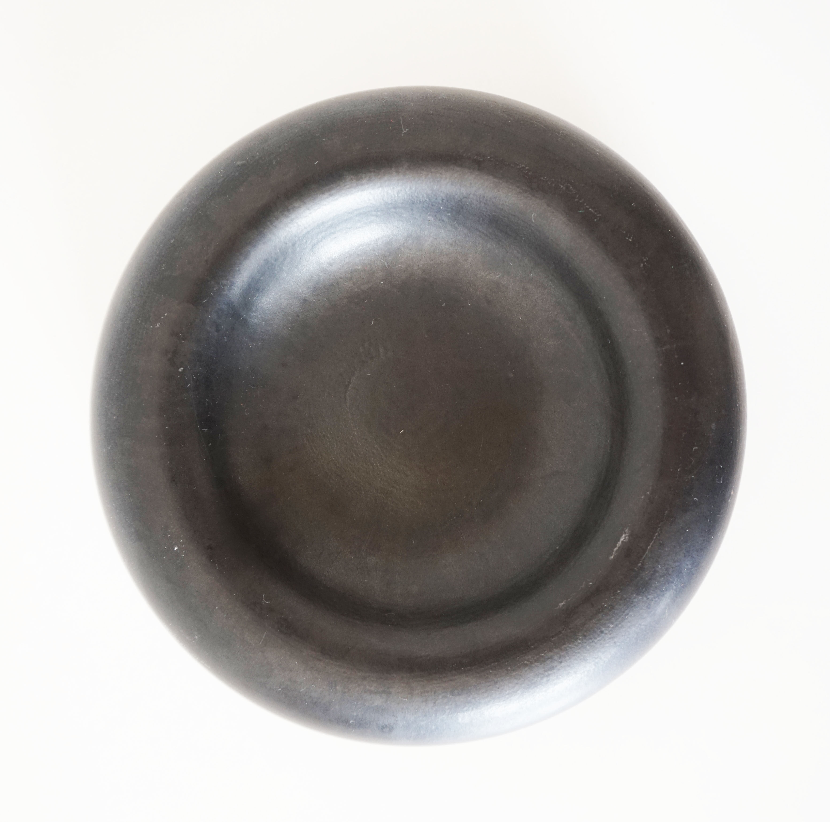 Empty round pocket in black ceramic