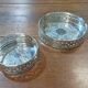 A pair of silver-plated bottle coasters for 75cl and 25cl.