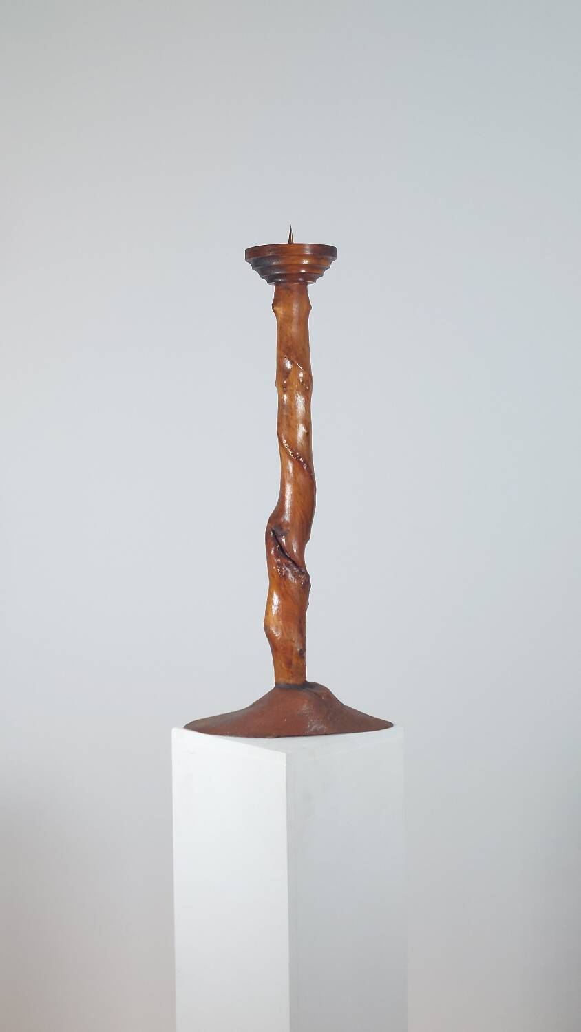 Vintage candle holder in an organic shape with a brass spike and tiered top.