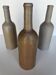 Trio of antique matte stoneware bottles
