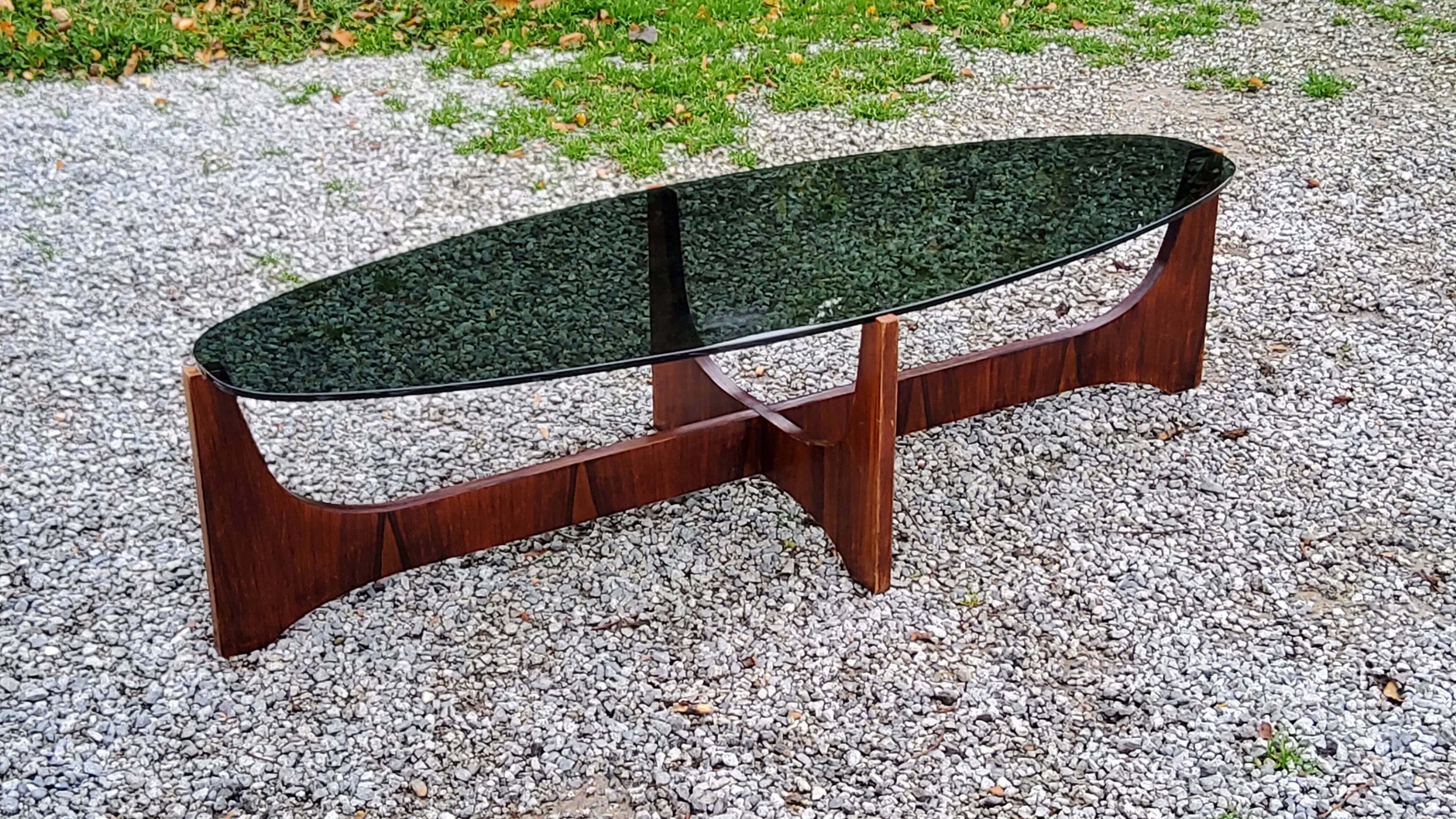 Designer coffee table by Hugues Poignant in rosewood and smoked glass from the 70s