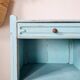 Small vintage bedside table in azure blue patina.
