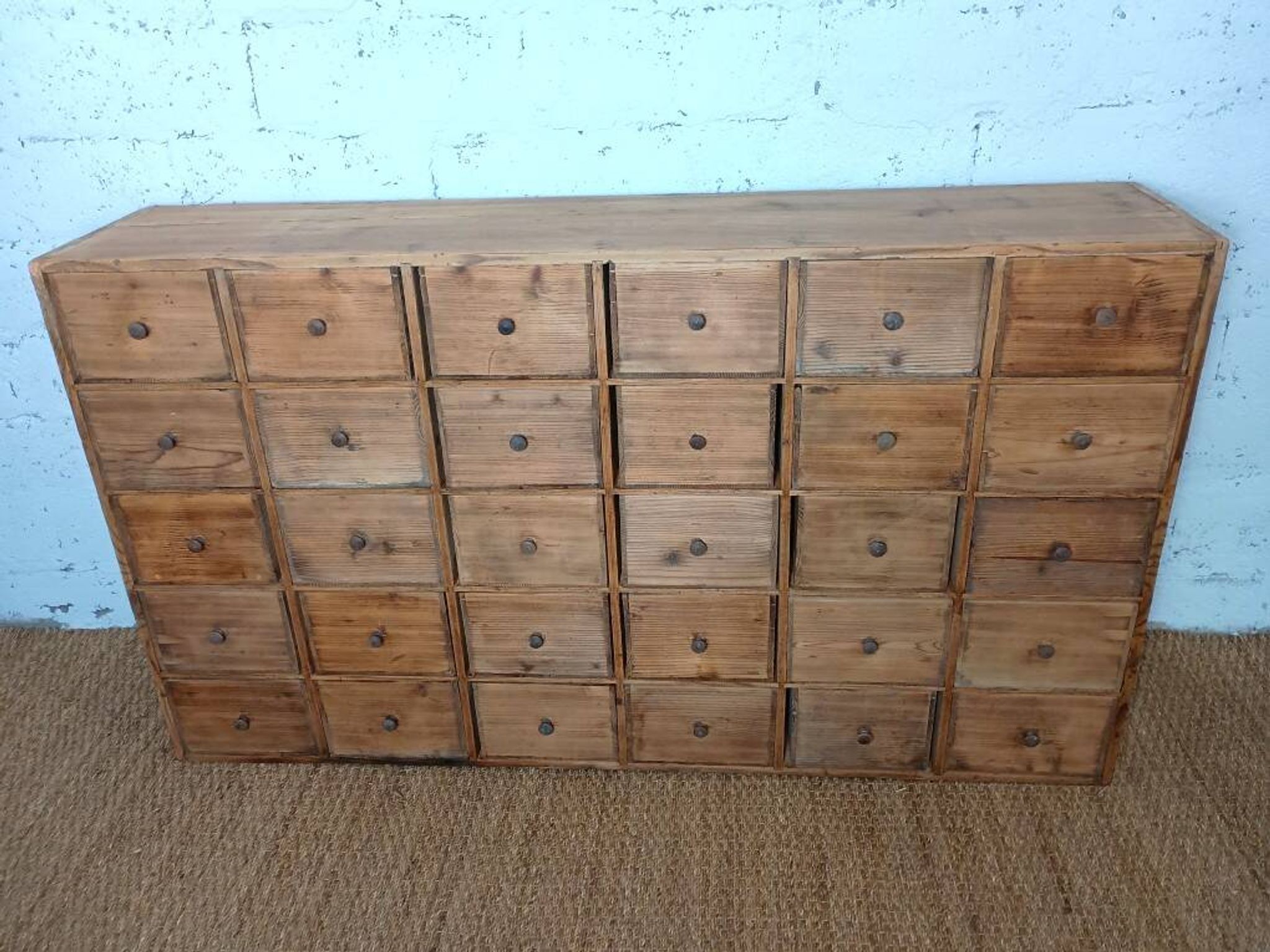 Industrial or apothecary workbench with 30 vintage wooden drawers.