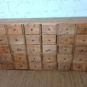 Industrial or apothecary workbench with 30 vintage wooden drawers.