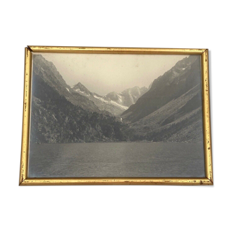 Photo in black and white mountain lake in golden frame