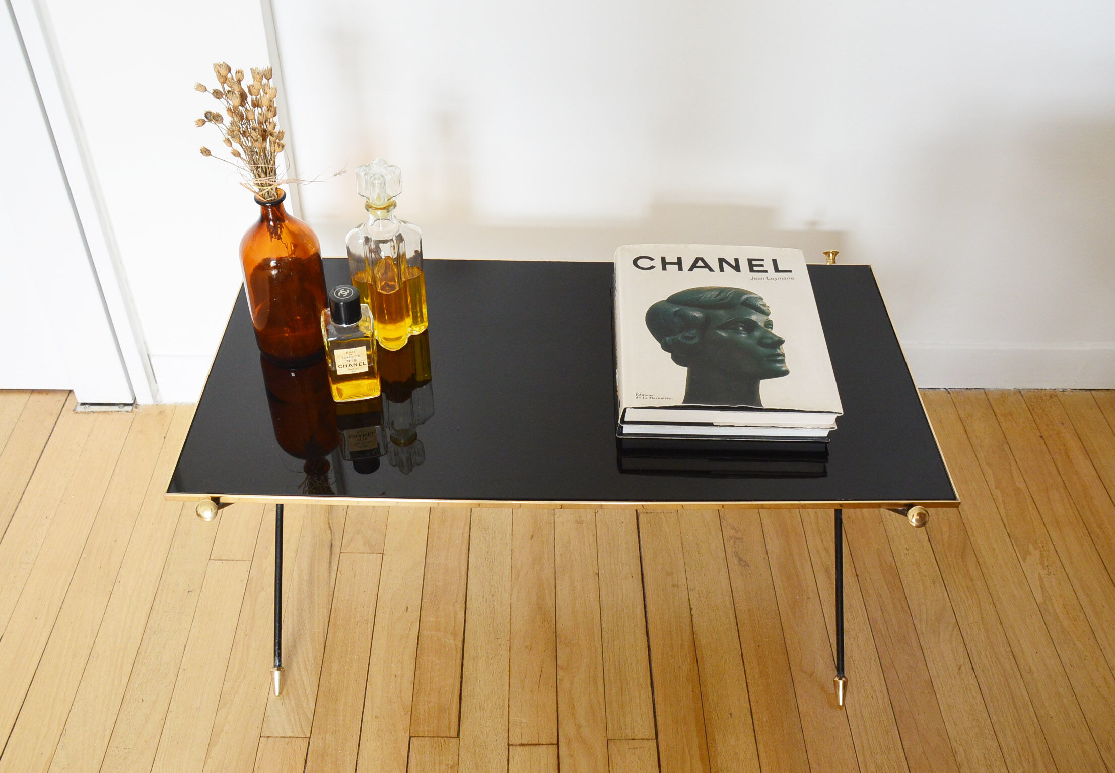 Black glass and brass coffee table in the 1960s