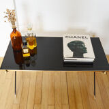 Black glass and brass coffee table in the 1960s