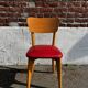 Set of 4 vintage bistro chairs in wood and red faux leather, with splayed legs.