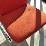 The 1970s orange armchair fabric and chrome metal