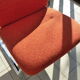 The 1970s orange armchair fabric and chrome metal