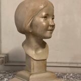 Plaster bust, young girl, monogram and date.
