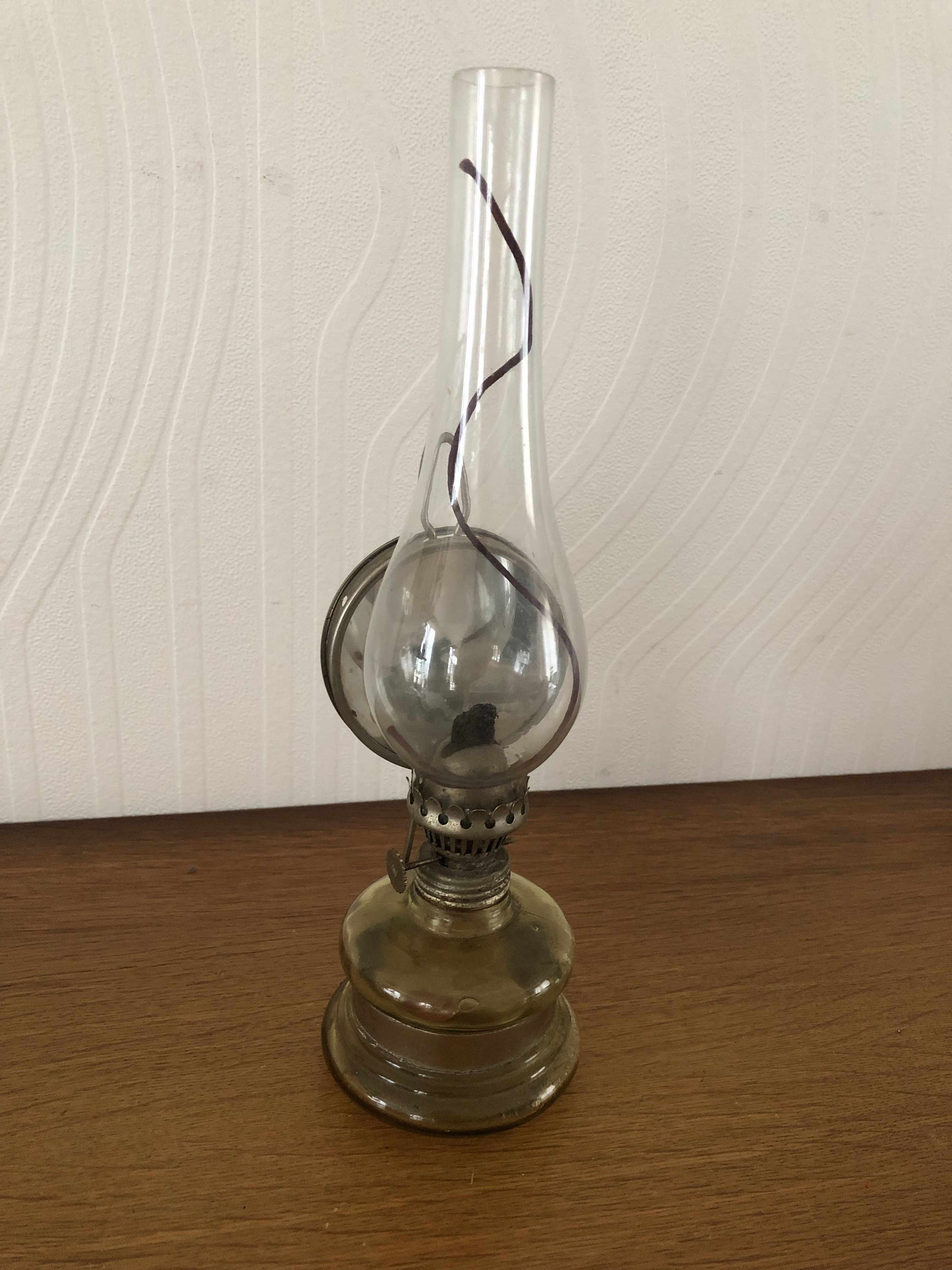 Oil lamp with glass pedestal and integrated round mirror