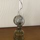 Oil lamp with glass pedestal and integrated round mirror
