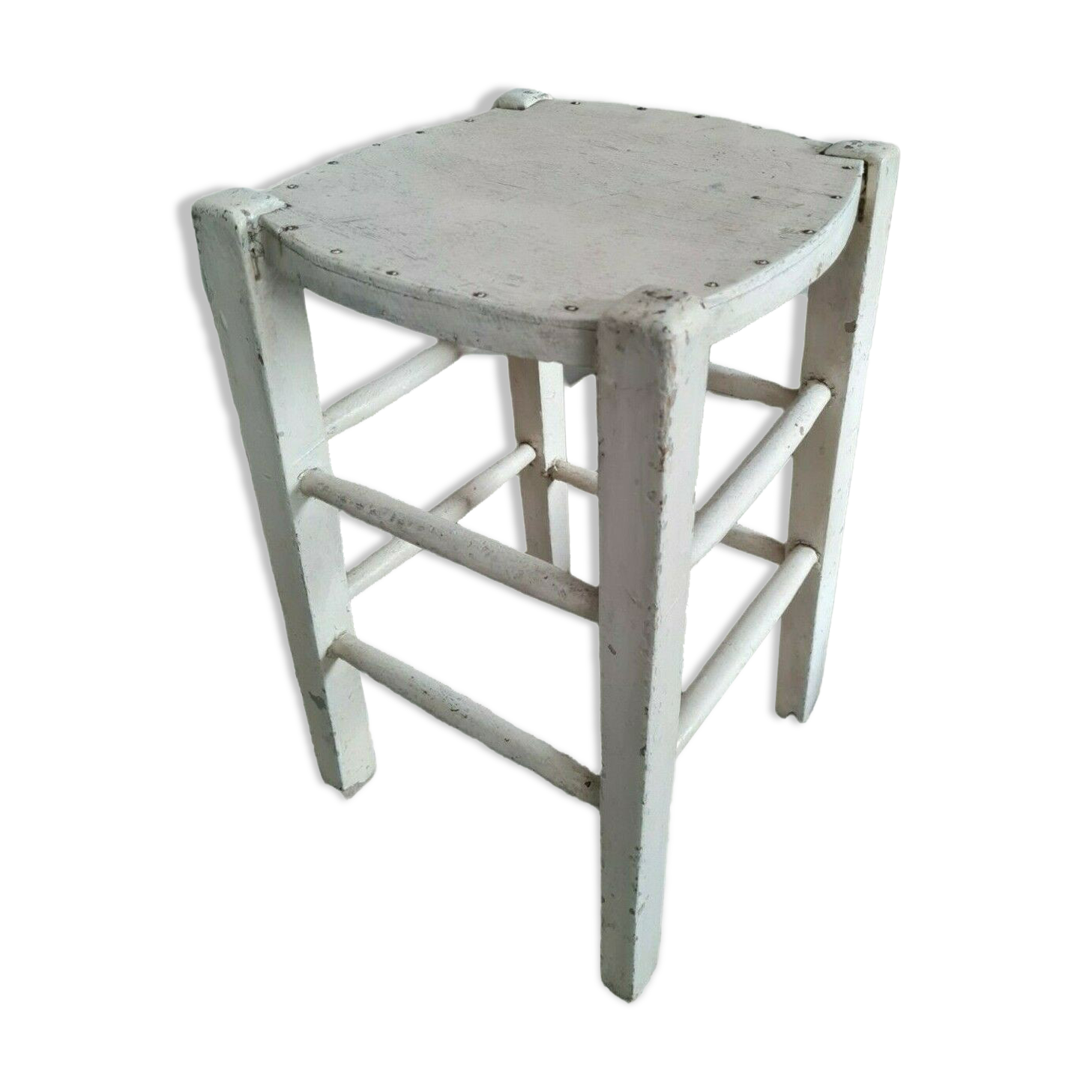 Vintage wooden stool with white peeling paint