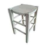Vintage wooden stool with white peeling paint
