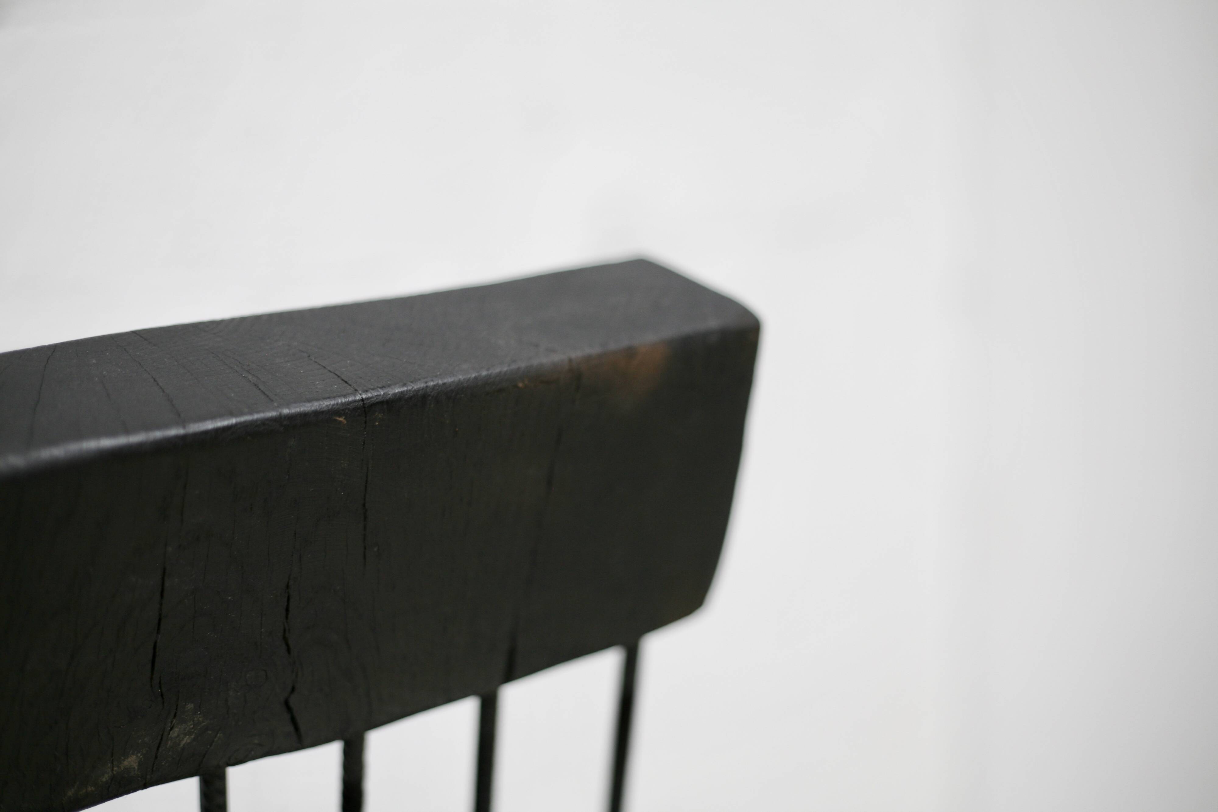 Brutalist chair, black-stained raw wood, steel. Work from the 1970s