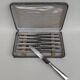 Box of 12 table knives in silver metal, art deco period.