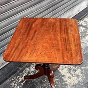19th-century solid mahogany table with a tilting top and brass mechanism.