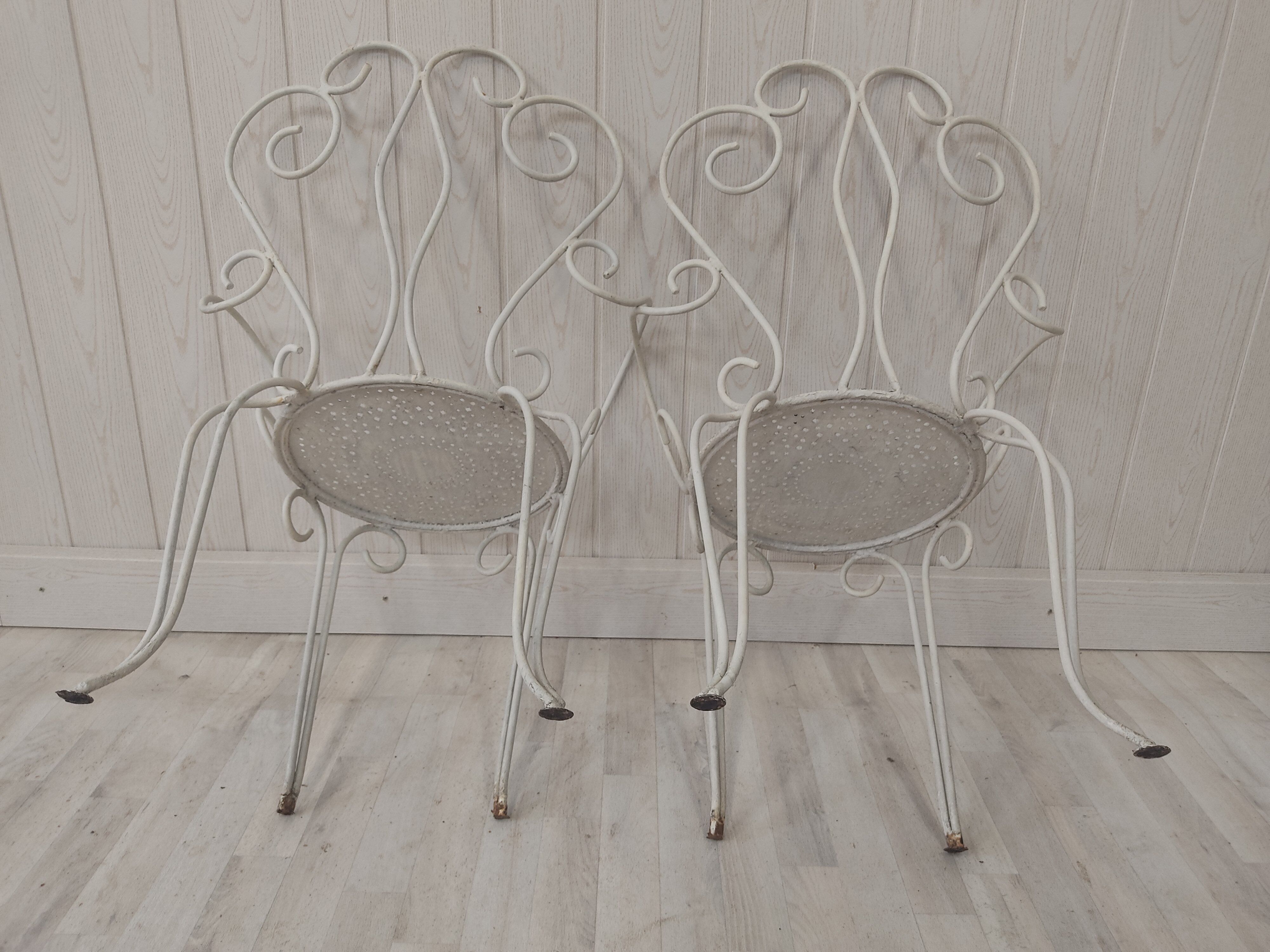 Pair of wrought iron garden chairs