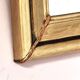 Art Deco mirror in gilded wood with curved floral decorations.