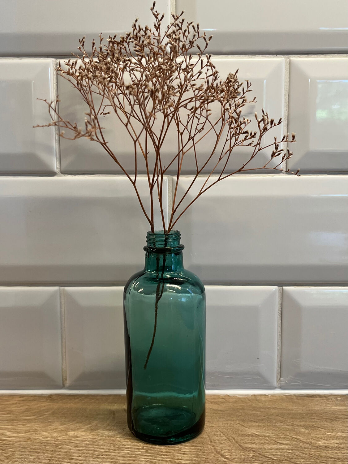 Small vintage dark turquoise blue bottle