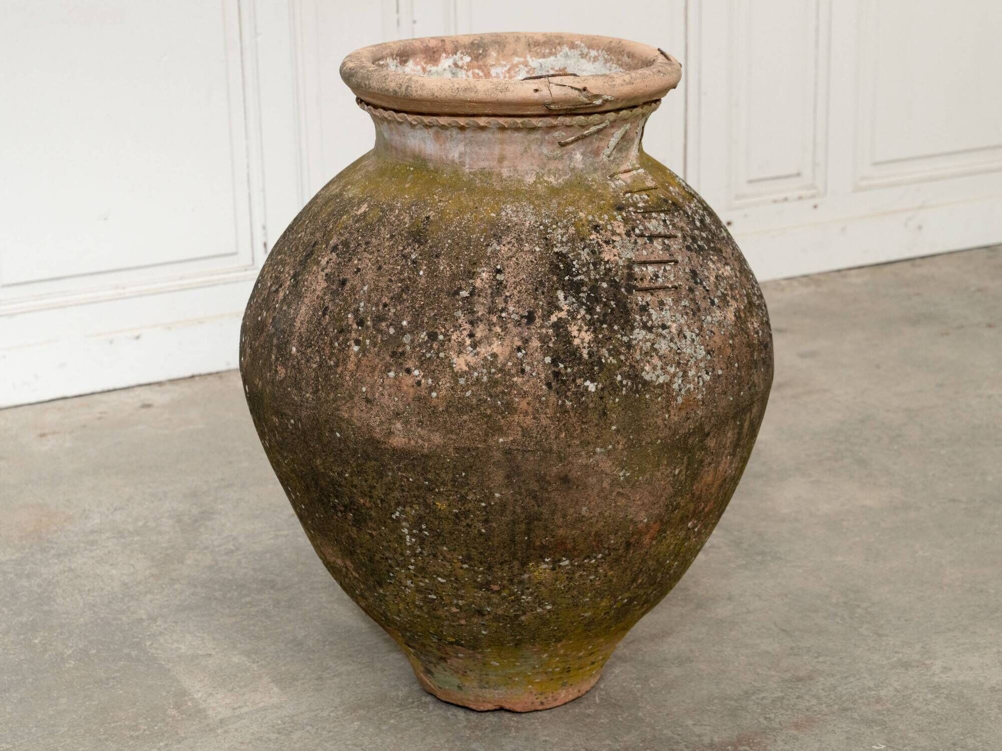 Old terracotta jar with its metal clasps, late 19th century.