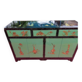 Lacquered buffet in soft green with floral patterns.