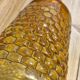 Artisanal blown amber glass vase with integrated honeycomb structure.