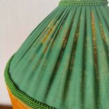 Green ceramic lamp with a vintage pleated fringe shade.