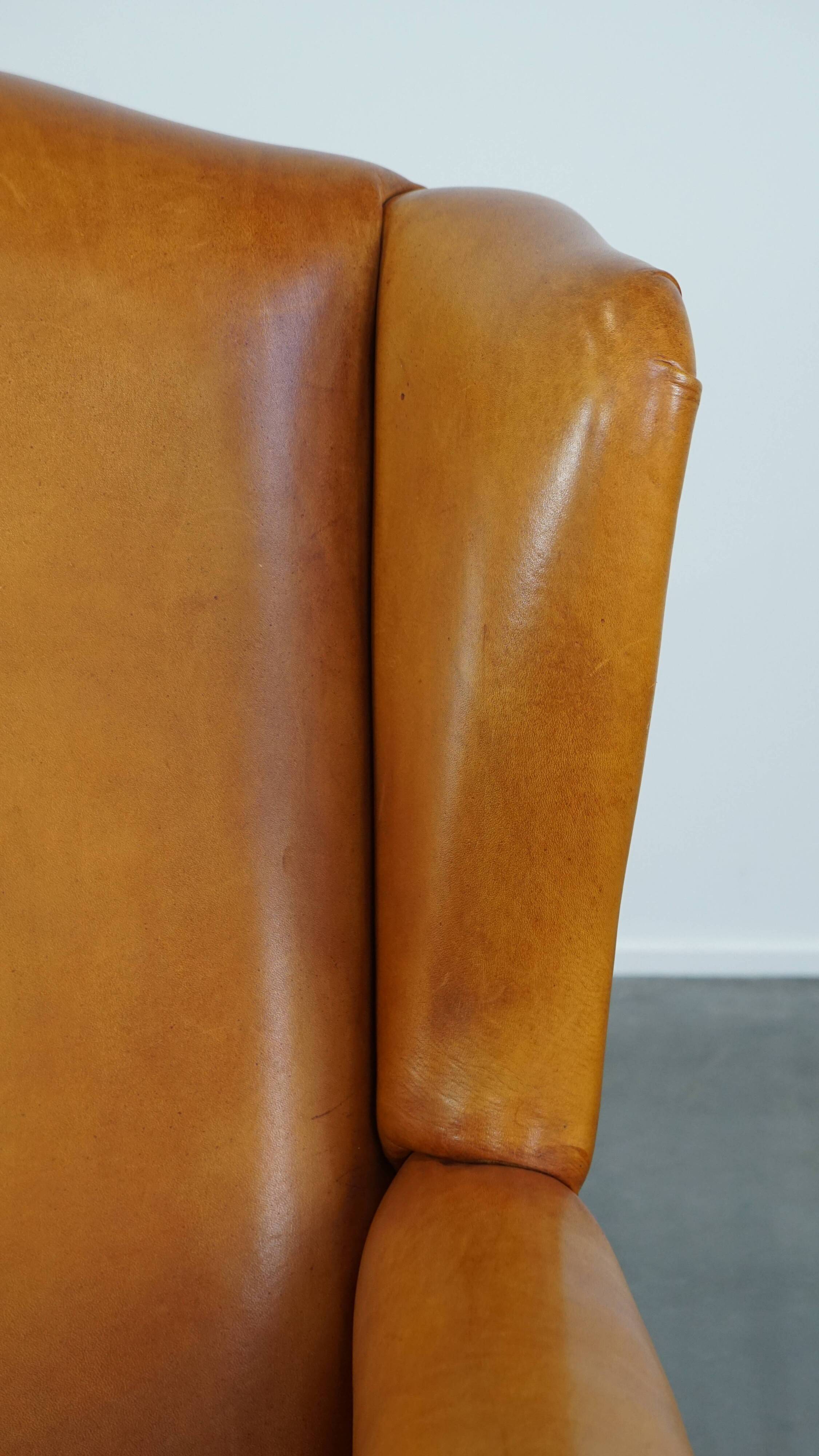 Cow leather wingback chair finished with decorative nails