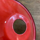 Suspension in red enamelled sheet metal