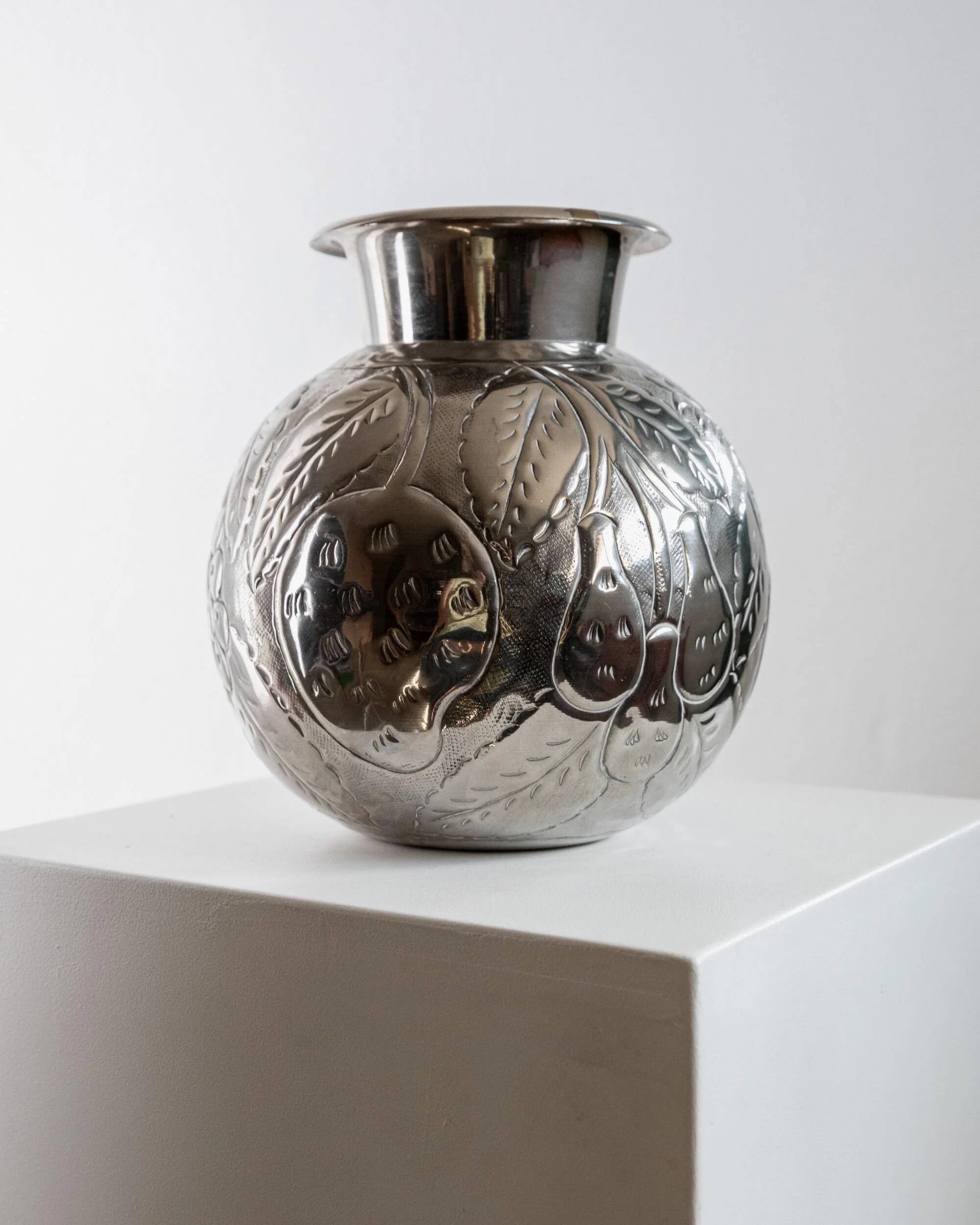Vintage Italian vase in nickel-plated brass from the 1960s, hand-hammered relief of fruits and leaves.