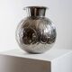 Vintage Italian vase in nickel-plated brass from the 1960s, hand-hammered relief of fruits and leaves.